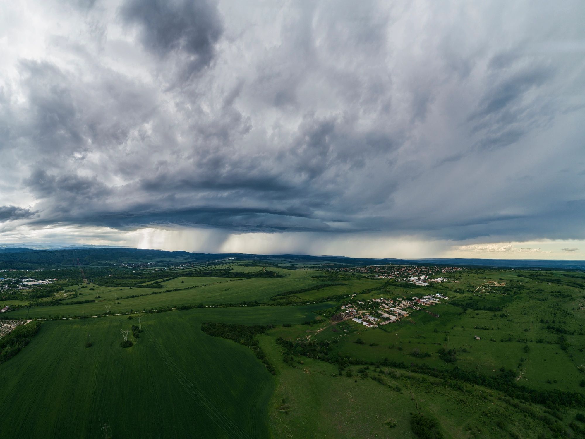 Dramatic storm clouds over open farmland