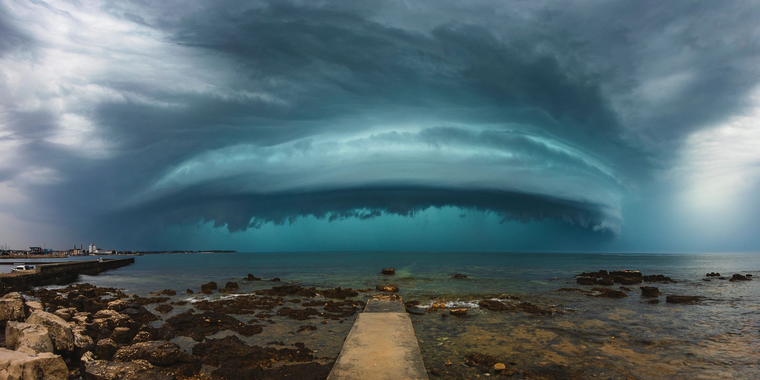 Shelf cloud arcus storm over the sea near a pier
