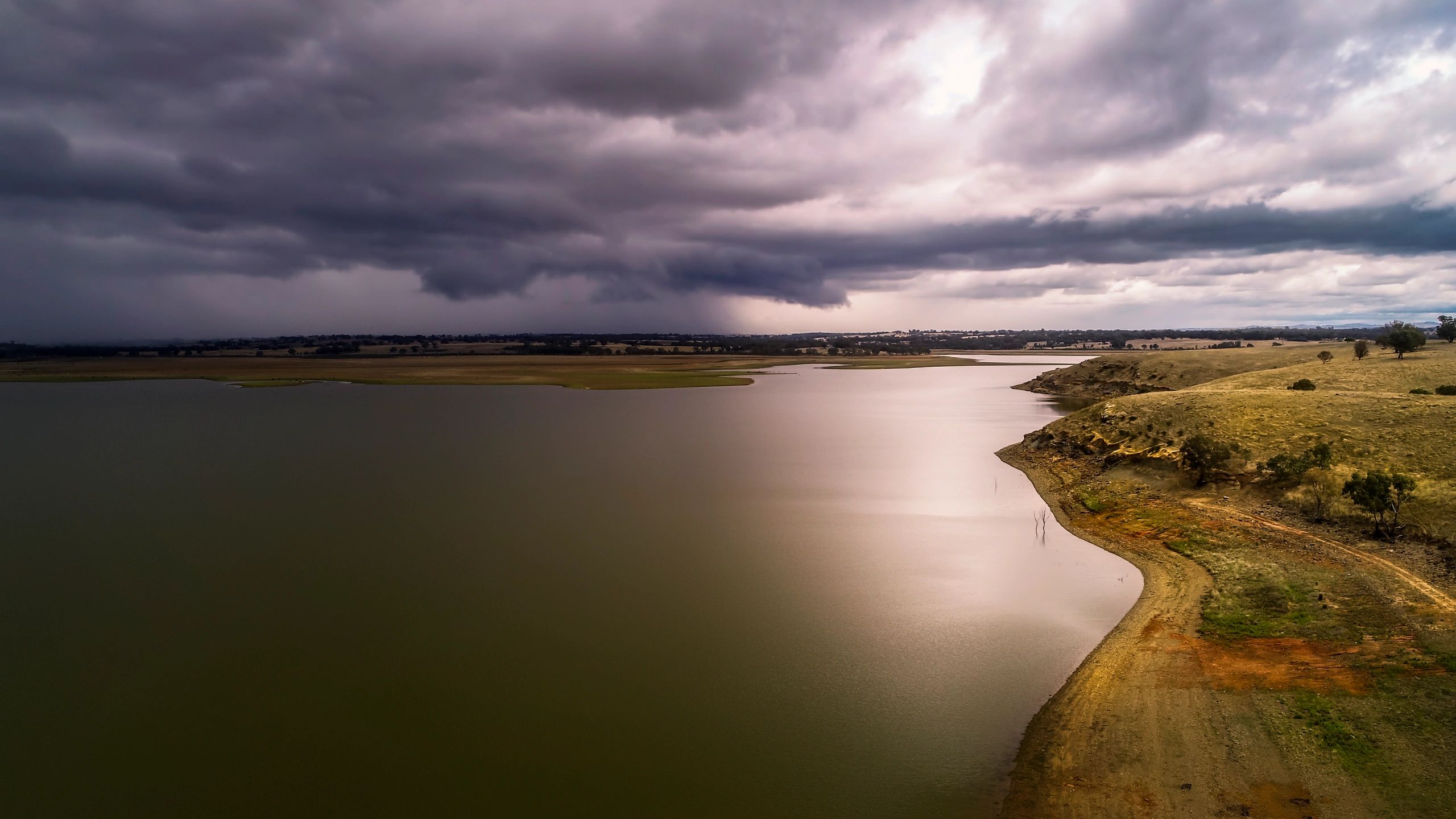 Distant storm clouds gathering over a wide horizon