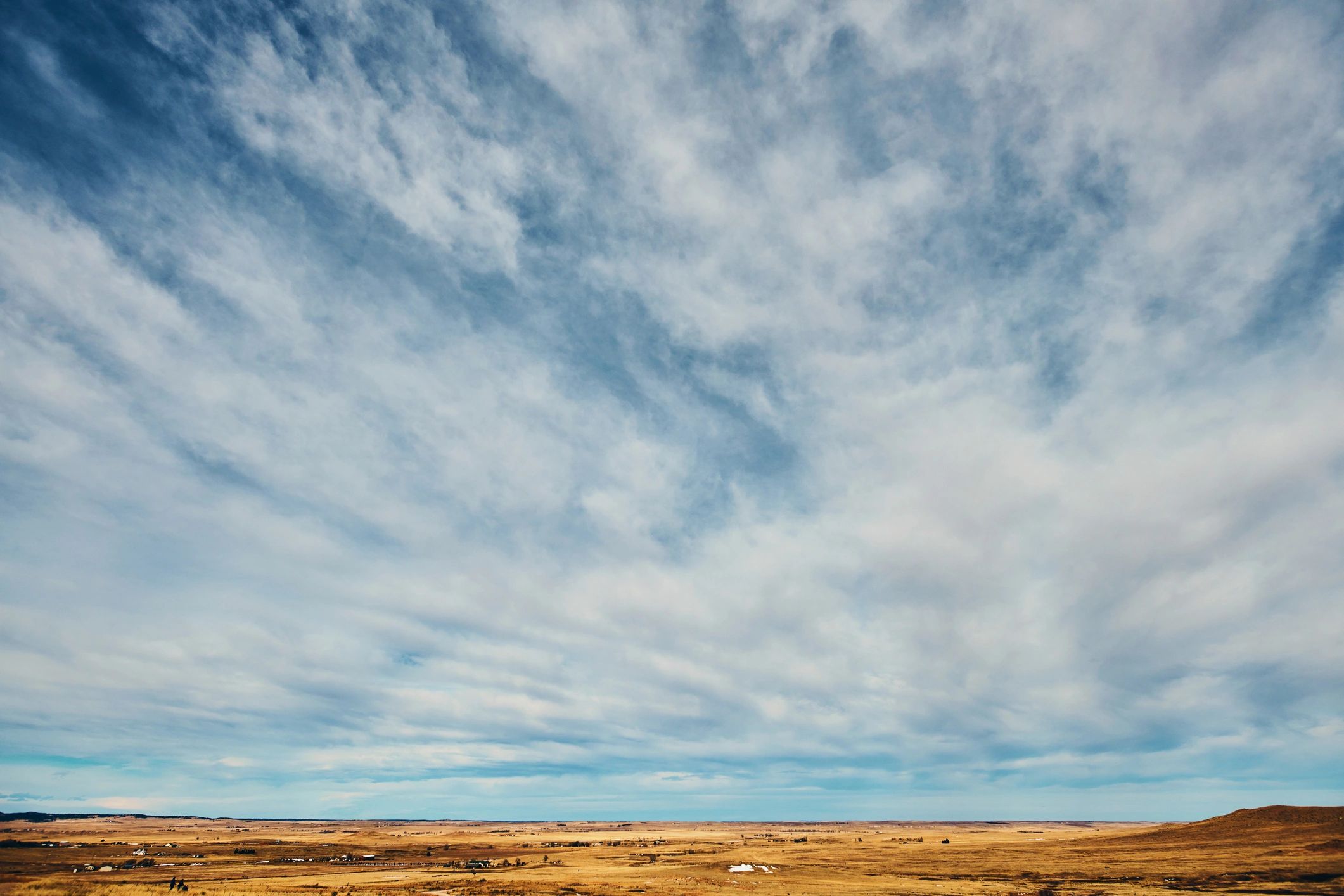 Open fields under a wide blue sky