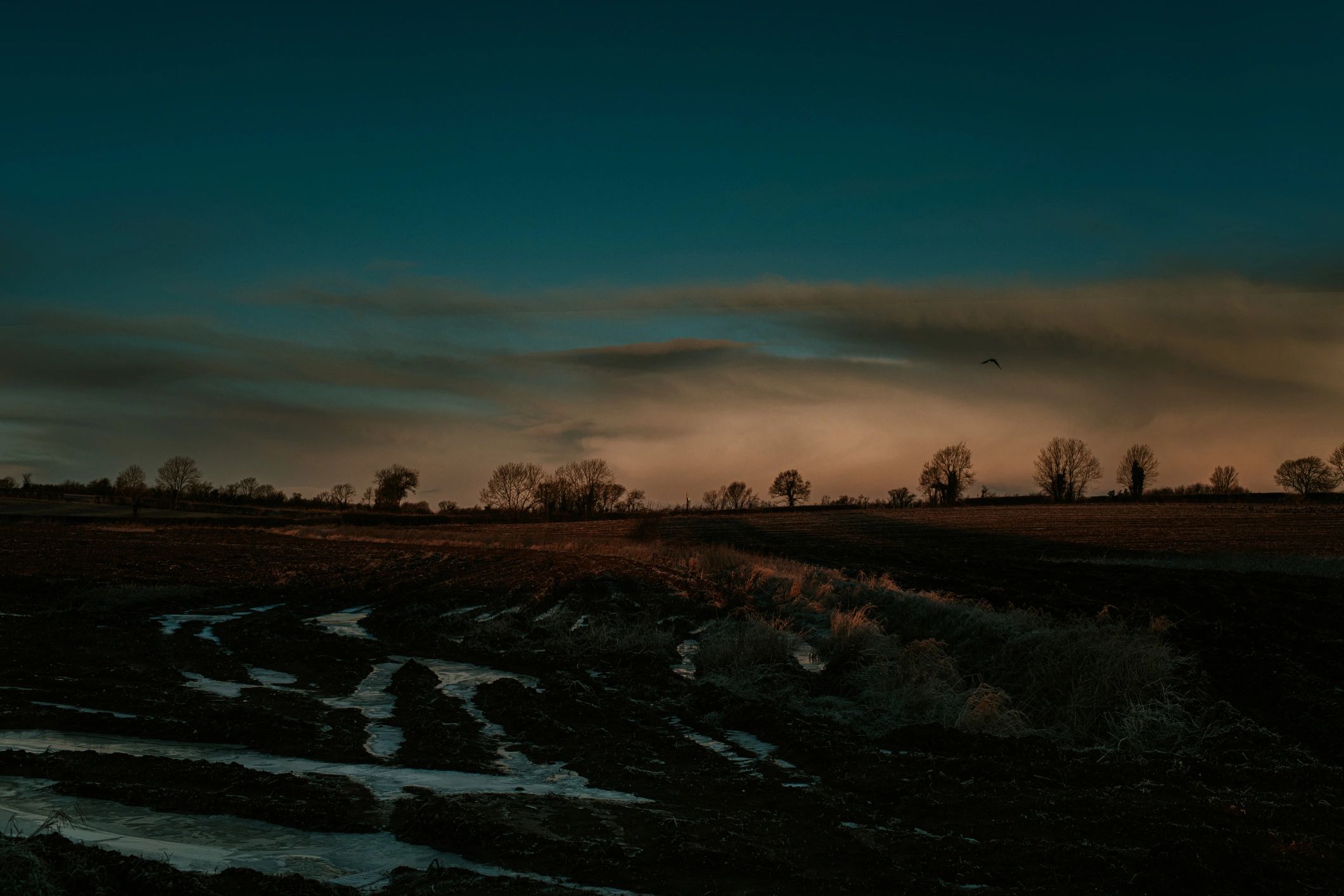 Wide landscape at sunrise or sunset under changing skies