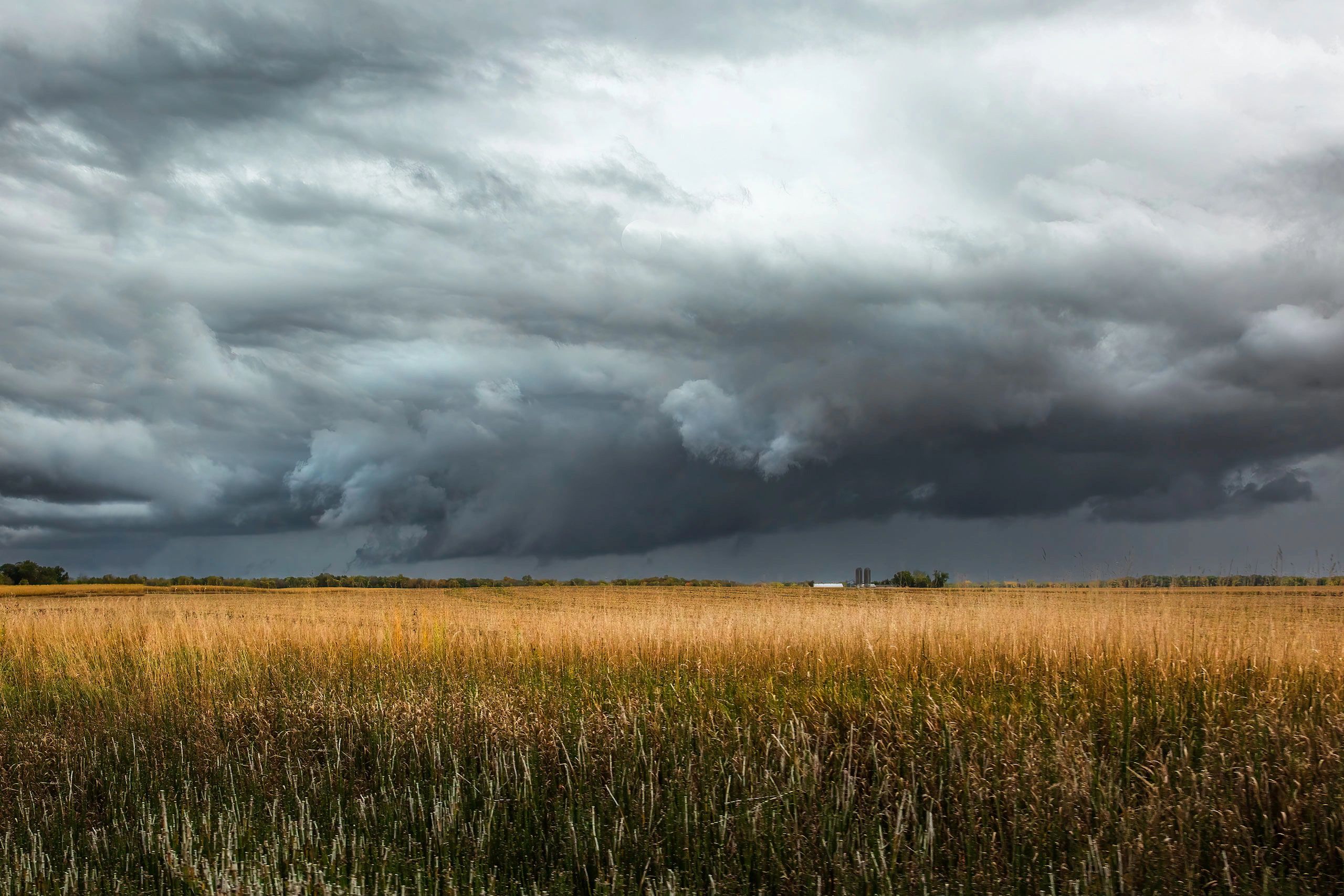 Dramatic storm clouds over an open field