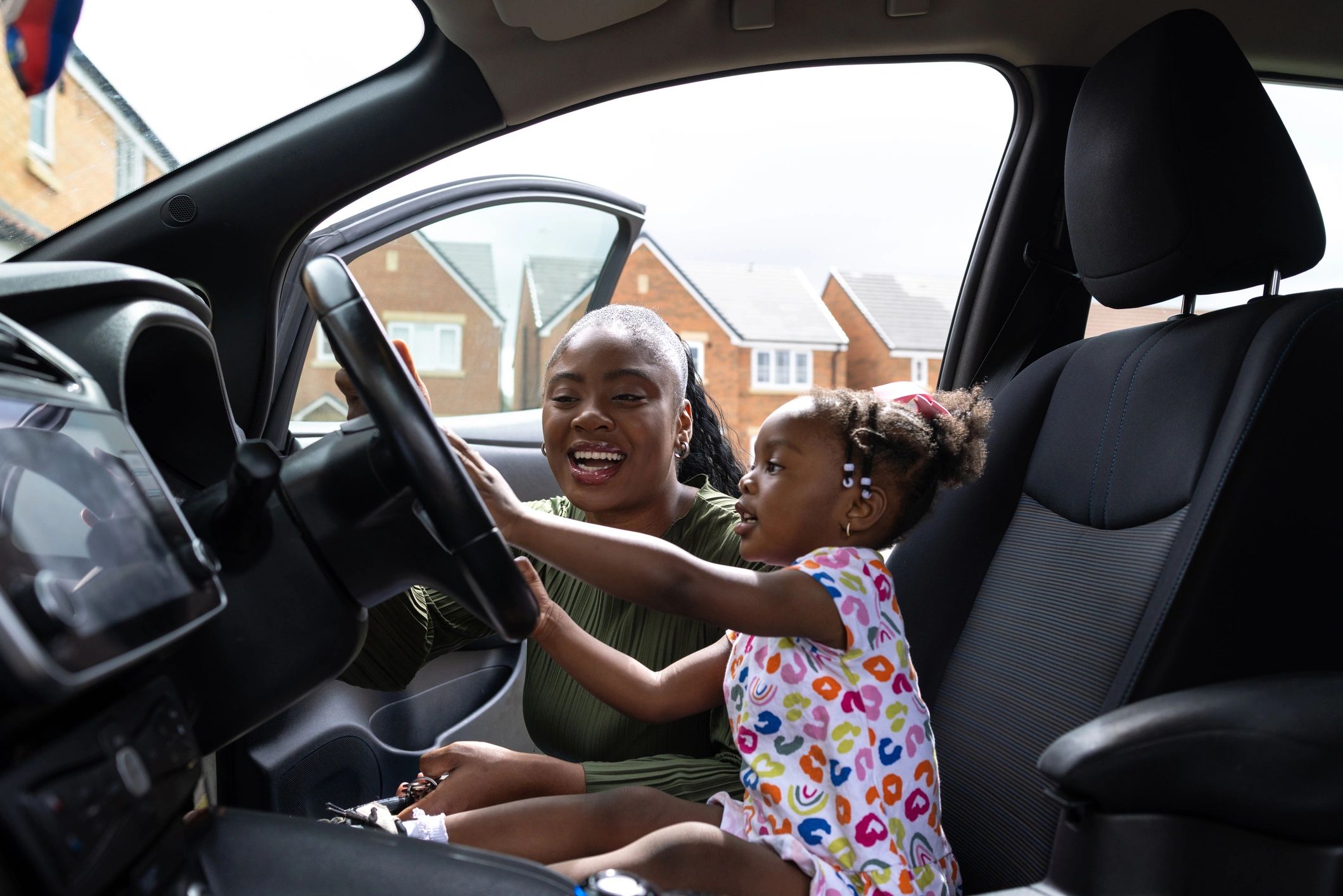Person inside a vehicle holding a tablet (illustrative of using apps on the road)