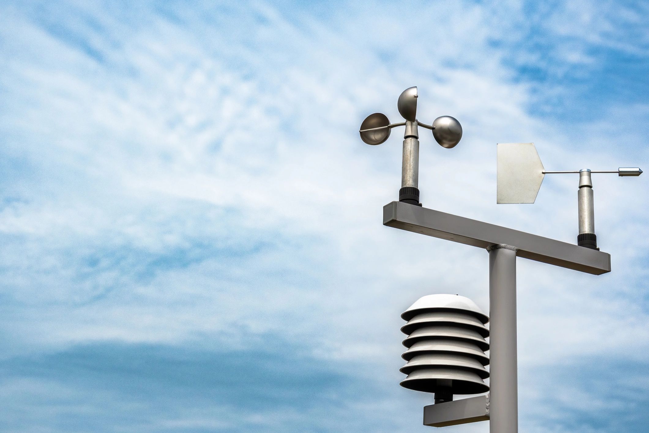 Weather station instruments under a cloudy sky